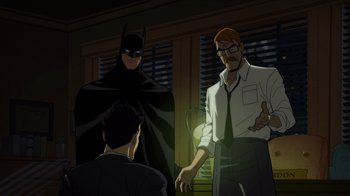 Movie still from “Batman: The Long Halloween” (2021), directed by Chris Palmer – Two men and a batman talking to each other in a dark room; Medium shot, Over the shoulder angle
