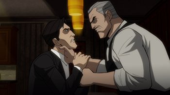 Movie still from “Batman: The Long Halloween” (2021), directed by Chris Palmer – Two men in business suits are holding hands; Close Up shot, Over the shoulder angle