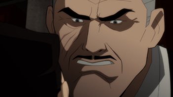 Movie still from “Batman: The Long Halloween” (2021), directed by Chris Palmer – An animated face of a man with an angry look; Extreme Close Up shot, Over the shoulder angle
