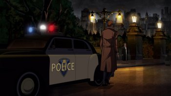 Movie still from “Batman: The Long Halloween” (2021), directed by Chris Palmer – A police car parked on the side of the road; Extreme Wide shot, Over the shoulder angle