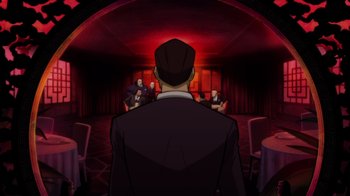 Movie still from “Batman: The Long Halloween” (2021), directed by Chris Palmer – A group of people sitting in a room; Wide shot, Over the shoulder angle