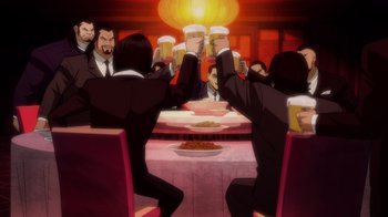 Movie still from “Batman: The Long Halloween” (2021), directed by Chris Palmer – A group of people sitting at a table with drinks; Wide shot, Low angle