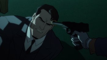 Movie still from “Batman: The Long Halloween” (2021), directed by Chris Palmer – A man in a suit and tie holding a gun; Close Up shot, High angle