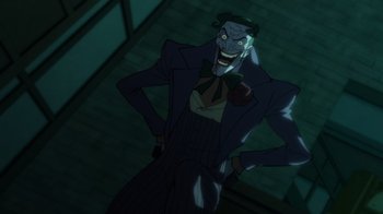 Movie still from “Batman: The Long Halloween” (2021), directed by Chris Palmer – A cartoon of a man in a suit and tie smiling; Medium shot, Low angle