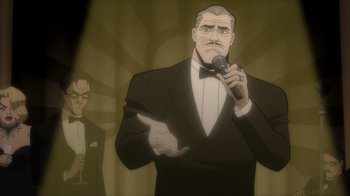 Movie still from “Batman: The Long Halloween” (2021), directed by Chris Palmer – An animated man in a suit is holding a microphone; Medium shot, Low angle