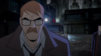 Movie still from “Batman: The Long Halloween” (2021), directed by Chris Palmer – An animated picture of a man with a beard and glasses; Close Up shot, Over the shoulder angle