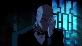 Movie still from “Batman: The Long Halloween, Part Two” (2021), directed by Chris Palmer – An old bald man with a bow tie is holding his hand up to his face; Close Up shot, Over the shoulder angle