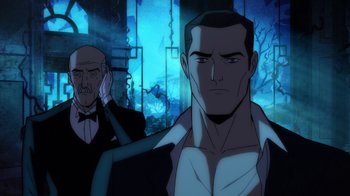 Movie still from “Batman: The Long Halloween, Part Two” (2021), directed by Chris Palmer – A man in a suit standing next to another man in a suit; Medium shot, Over the shoulder angle