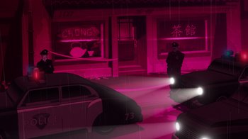 Movie still from “Batman: The Long Halloween, Part Two” (2021), directed by Chris Palmer – A man standing in front of a car on a street; Extreme Wide shot, Low angle