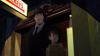 Movie still from “Batman: The Long Halloween, Part Two” (2021), directed by Chris Palmer – A man and a boy standing next to each other in front of a building; Medium shot, Over the shoulder angle