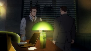 Movie still from “Batman: The Long Halloween, Part Two” (2021), directed by Chris Palmer – Two men are standing at a table with a green lamp on top of it; Medium shot, High angle