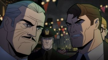 Movie still from “Batman: The Long Halloween, Part Two” (2021), directed by Chris Palmer – A group of men standing next to each other in front of lights; Close Up shot, Over the shoulder angle