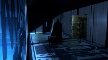 Movie still from “Batman: The Long Halloween, Part Two” (2021), directed by Chris Palmer – A dark room with a bat in the middle of the room; Extreme Wide shot, High angle