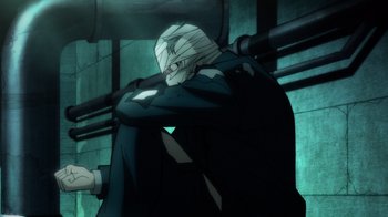 Movie still from “Batman: The Long Halloween, Part Two” (2021), directed by Chris Palmer – A man in a suit and tie sitting on a chair; Wide shot, High angle