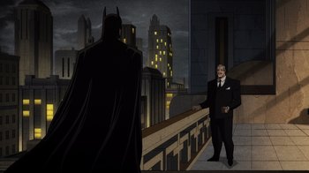 Movie still from “Batman: The Long Halloween, Part Two” (2021), directed by Chris Palmer – A cartoon of a man in a suit standing next to a batman; Wide shot, Over the shoulder angle