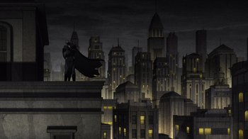 Movie still from “Batman: The Long Halloween, Part Two” (2021), directed by Chris Palmer – A man standing on top of a building in the dark; Extreme Wide shot, Low angle
