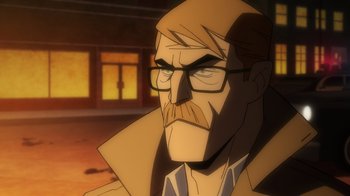 Movie still from “Batman: The Long Halloween, Part Two” (2021), directed by Chris Palmer – An animated picture of a man with a beard and glasses; Close Up shot, Over the shoulder angle