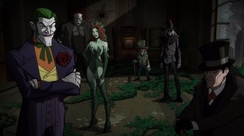 Movie still from “Batman: The Long Halloween, Part Two” (2021), directed by Chris Palmer – A group of people standing around in a room; Wide shot, Low angle