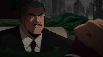 Movie still from “Batman: The Long Halloween, Part Two” (2021), directed by Chris Palmer – An older man in a suit and tie looking to his left; Close Up shot, Over the shoulder angle