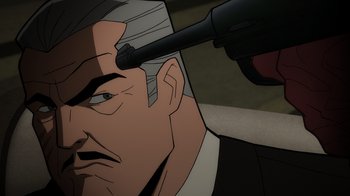 Movie still from “Batman: The Long Halloween, Part Two” (2021), directed by Chris Palmer – An animated picture of a man with a gun pointed at his head; Close Up shot, High angle