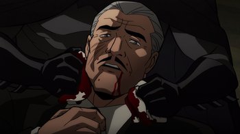 Movie still from “Batman: The Long Halloween, Part Two” (2021), directed by Chris Palmer – An old man with blood on his face and holding an umbrella; Close Up shot, Overhead angle