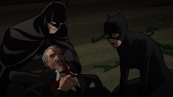 Movie still from “Batman: The Long Halloween, Part Two” (2021), directed by Chris Palmer – A man in a black suit and a woman in a black suit and a man in a black suit and a man in a black suit; Medium shot, High angle