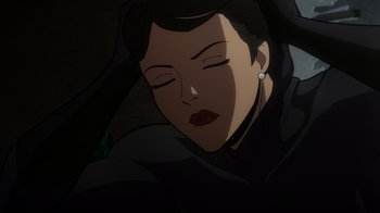 Movie still from “Batman: The Long Halloween, Part Two” (2021), directed by Chris Palmer – A woman's face in a dark room; Close Up shot, Low angle