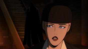 Movie still from “Batman: The Long Halloween, Part Two” (2021), directed by Chris Palmer – A woman in a black jacket and a black hat; Close Up shot, Over the shoulder angle