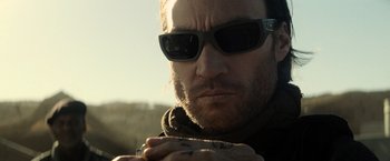 Movie still from “Batman v Superman: Dawn of Justice” (2016), directed by Zack Snyder – A person wearing sunglasses; Close Up shot, Over the shoulder angle