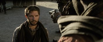 Movie still from “Batman v Superman: Dawn of Justice” (2016), directed by Zack Snyder – A man with a beard is holding a gun; Close Up shot, Over the shoulder angle