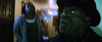 Movie still from “Batman v Superman: Dawn of Justice” (2016), directed by Zack Snyder – A person with a hat on; Close Up shot, Low angle