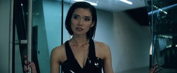 Movie still from “Batman v Superman: Dawn of Justice” (2016), directed by Zack Snyder – A woman in a black dress looking at the camera; Close Up shot, Low angle