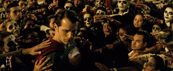 Movie still from “Batman v Superman: Dawn of Justice” (2016), directed by Zack Snyder – A crowd of people in costumes surrounding a man in costume; Medium shot, Over the shoulder angle