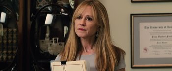 Movie still from “Batman v Superman: Dawn of Justice” (2016), directed by Zack Snyder – A person holding a folder; Close Up shot, Over the shoulder angle