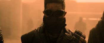 Movie still from “Batman v Superman: Dawn of Justice” (2016), directed by Zack Snyder – A man wearing sunglasses and wearing a mask; Close Up shot, Over the shoulder angle