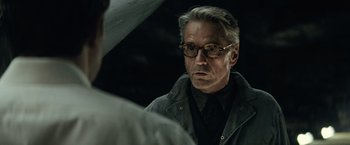 Movie still from “Batman v Superman: Dawn of Justice” (2016), directed by Zack Snyder – A person wearing glasses and a jacket; Close Up shot, Over the shoulder angle