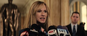 Movie still from “Batman v Superman: Dawn of Justice” (2016), directed by Zack Snyder – A person talking into microphones; Close Up shot, Over the shoulder angle