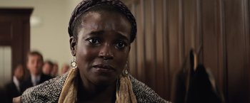 Movie still from “Batman v Superman: Dawn of Justice” (2016), directed by Zack Snyder – A person wearing a headscarf; Close Up shot, Over the shoulder angle