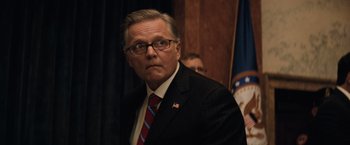 Movie still from “Batman v Superman: Dawn of Justice” (2016), directed by Zack Snyder – A person wearing a suit and tie; Close Up shot, Low angle