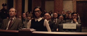 Movie still from “Batman v Superman: Dawn of Justice” (2016), directed by Zack Snyder – A group of people sitting in front of a crowd; Medium shot, Over the shoulder angle