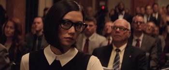 Movie still from “Batman v Superman: Dawn of Justice” (2016), directed by Zack Snyder – A woman wearing glasses in a crowd of people; Close Up shot, Over the shoulder angle