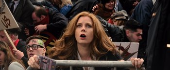 Movie still from “Batman v Superman: Dawn of Justice” (2016), directed by Zack Snyder – A woman with long red hair is looking upward; Close Up shot, Low angle