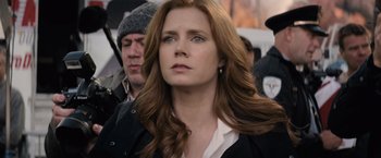 Movie still from “Batman v Superman: Dawn of Justice” (2016), directed by Zack Snyder – A person with long red hair; Close Up shot, Over the shoulder angle