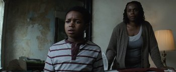 Movie still from “Batman v Superman: Dawn of Justice” (2016), directed by Zack Snyder – A young boy standing next to a mirror; Close Up shot, Low angle