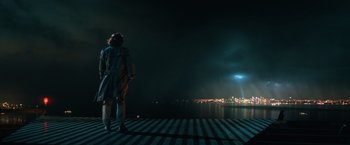 Movie still from “Batman v Superman: Dawn of Justice” (2016), directed by Zack Snyder – A person standing on a rail road track at night; Extreme Wide shot, Low angle