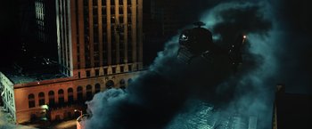 Movie still from “Batman v Superman: Dawn of Justice” (2016), directed by Zack Snyder – A helicopter flying through the air at night with smoke billowing out of it; Extreme Wide shot, High angle