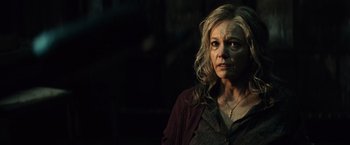 Movie still from “Batman v Superman: Dawn of Justice” (2016), directed by Zack Snyder – A woman in a red shirt and a black background; Close Up shot, Over the shoulder angle