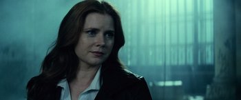 Movie still from “Batman v Superman: Dawn of Justice” (2016), directed by Zack Snyder – A person wearing a jacket; Close Up shot, Over the shoulder angle