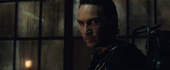 Movie still from “Batman v Superman: Dawn of Justice” (2016), directed by Zack Snyder – A person wearing a black shirt; Close Up shot, Low angle