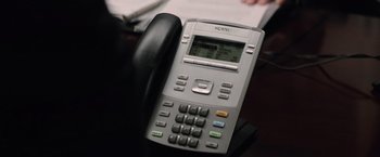 Movie still from “Batman v Superman: Dawn of Justice” (2016), directed by Zack Snyder – A phone on a desk; Extreme Close Up shot, High angle